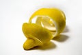 Lemon peel or lemon twist on white background. Close-up. Citrus limon. Royalty Free Stock Photo