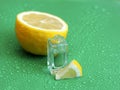 Lemon perfume on green background