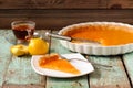 Lemon pie with fresh and squeezed lemon, cup of tea on old paint Royalty Free Stock Photo