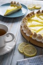 Lemon pie with tea next to the window