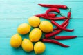 Lemon red, pepers on blue wooden kitchen background. Copy space and mock up