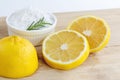 Lemon and sea salt - Beauty treatment with organic cosmetics with lemon ingredients on wood and rosemary background for body scrub Royalty Free Stock Photo