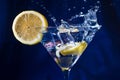 Lemon slice falling into a martini glass cocktail Royalty Free Stock Photo
