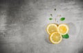 Lemon slice with mint leaves on gray table. Fresh citrous fruits piece, isolated with copyspace Royalty Free Stock Photo