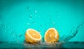 Lemon Slices falling for water with a big splash on blue backgro Royalty Free Stock Photo