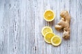 Lemon slices and ginger root on wooden background Royalty Free Stock Photo