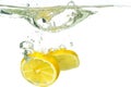 Lemon slices and lime falling into water and splash on white background Royalty Free Stock Photo