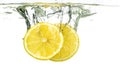 Lemon slices and lime falling into water and splash on white background Royalty Free Stock Photo