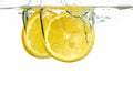 Lemon slices and lime falling into water and splash on white background Royalty Free Stock Photo