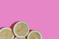 Lemon slices on a pink background. CITRUS CITRIC