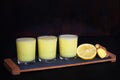 Lemon sour shots cocktails with ginger garnish