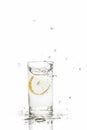 Lemon splashes in water glass isolated on white background