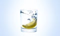 Lemon splashes in a water glass
