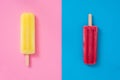 Lemon and strawberry popsicle on pink and blue background Royalty Free Stock Photo