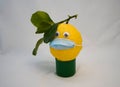 yellowe lemon with blue surgical mask Royalty Free Stock Photo