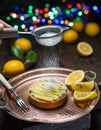 Lemon tart. Cooking of lemon dessert. Blurred festive background
