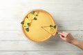 Lemon tart and person holding spatula with slice on background, top view Royalty Free Stock Photo