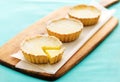 Lemon tarts on a wooden serving board Royalty Free Stock Photo