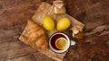 Lemon tea, home made jam, croissant on wooden table. Breakfast concept. Royalty Free Stock Photo