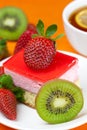 Lemon tea, kiwi,cake and strawberries Royalty Free Stock Photo