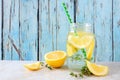 Lemon and thyme infused detox water in a mason jar against blue wood Royalty Free Stock Photo