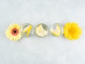 Lemon water drink with ice cubes on stone background with gerbera daisy yellow flowers Royalty Free Stock Photo