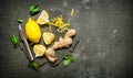 Lemon zest, ginger and leaves on a stone stand. Royalty Free Stock Photo