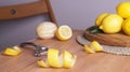 Lemon zest. Rind, fresh fruits and peeler on wooden table Royalty Free Stock Photo