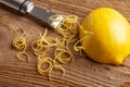 Lemon zest and Zester on wooden board