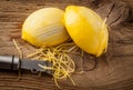Lemon zest and Zester on wooden board Royalty Free Stock Photo