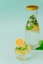 Lemonade in a bottle and in a glass on a blue background. lemon and mint. vitamin charge, antioxidant. healthy life. fresh ingredi Royalty Free Stock Photo