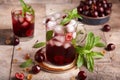 Lemonade with cherries, ice cubes, and mint. Refreshing beverage. Royalty Free Stock Photo