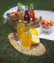 Lemonade with cherry, pear and lemon on the garden picnic