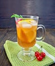 Lemonade with cherry in wineglass on napkin