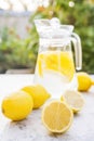 Lemonade close-up on a concrete background with lemons cut open. Whole lemons, mint, fresh summer lemonade in nature, the concept