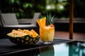 Lemonade cocktail with tropical fruits on the beach. Vacation background.