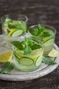 Lemonade with cucumber, lemon, mint and ginger in glass cups Royalty Free Stock Photo