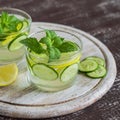 Lemonade with cucumber, lemon, mint and ginger in glass cups Royalty Free Stock Photo