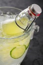 Lemonade with cucumber is served in a bottle with mint in a bucket with ice cubes. Royalty Free Stock Photo