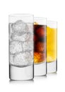 Lemonade drink with cola and orange soda with ice cubes on white background in highball glasses Royalty Free Stock Photo