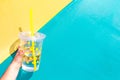 Lemonade drink in a glass on a colourful background.