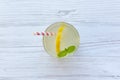 Lemonade drink in a glass with fresh lemon and mint over white wooden background, top view. Royalty Free Stock Photo