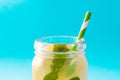 Lemonade drink in a jar glass on blue background. Royalty Free Stock Photo