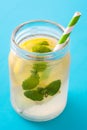 Lemonade drink in a jar glass on blue background. Royalty Free Stock Photo