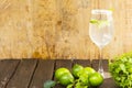 Lemonade in glass and green lemon on wooden background.Drink for health. Royalty Free Stock Photo