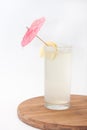 Lemonade in a glass with an umbrella and lemon Royalty Free Stock Photo