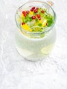 Lemonade juice with lime, lemon, mint leaves, cranberries. Fresh summer ice drink, detox water, ice cubes and glass pitcher Royalty Free Stock Photo