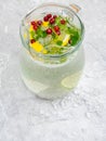 Lemonade juice with lime, lemon, mint leaves, cranberries. Fresh summer ice drink, detox water, ice cubes and glass pitcher Royalty Free Stock Photo