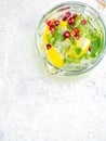 Lemonade Juice With Lime, Lemon, Mint Leaves, Cranberries. Fresh Summer Ice Drink, Detox Water, Ice Cubes And Glass Pitcher