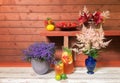 Lemonade, plate of strawberry, wicker basket with flowers, pink astilbe flowers in blue vase and lobelia blue blossom.